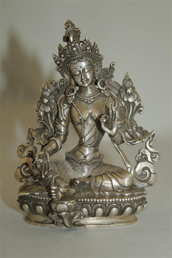 An unusual Tibetan silver seated figure of Green Tara, possibly 19th century, 11.7cm